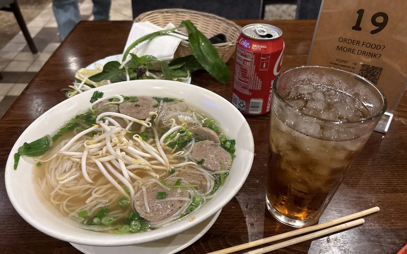 A bowl of meatball pho soup served at a Vietnamese restaurant, representing the international food culture of the area