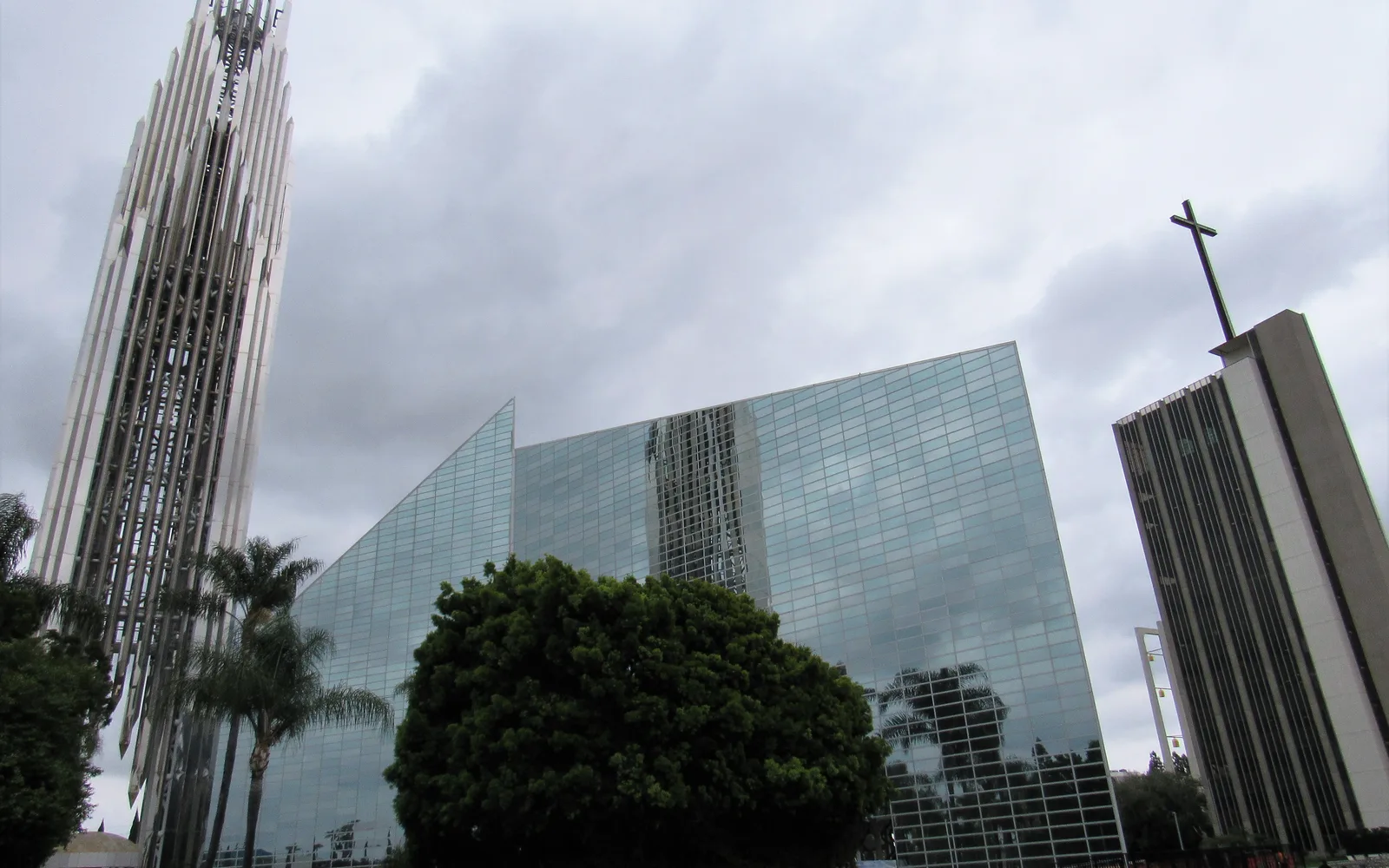 The modernist glass architecture of Christ Cathedral in Garden Grove, California, with its distinctive 128-foot spire against a clear sky